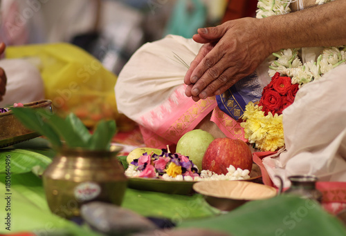 Tamil brahmin wedding -close up of hands performing pooja in indian tradition