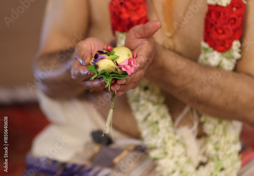 Tamil brahmin wedding -close up of hands performing pooja in indian tradition