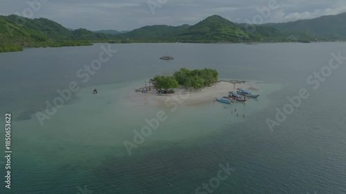 Small Tropical Island with Boats and Turquoise Water, Aerial View