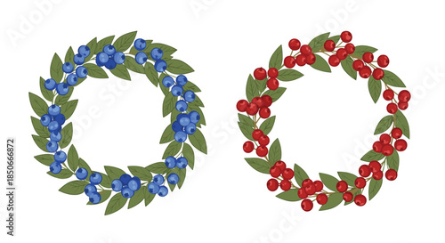 Pair of decorative botanical wreaths crafted from lush green leaves, one featuring blueberries and the other bright red berries.