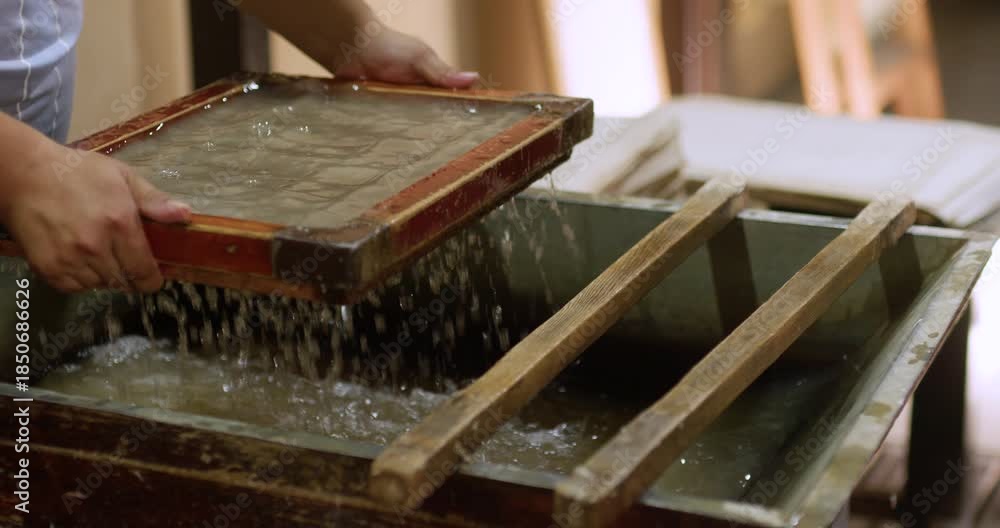 Fresh handmade paper sheets placed on a wooden press and drying surface ...