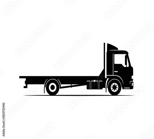 A striking silhouette of a large flatbed truck showcases its powerful build and design elements