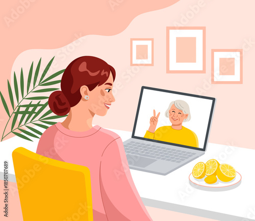 A young woman enjoying a video call with an elderly person, highlighting the warmth and connection between generations through technology and communication.