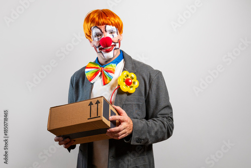 Clown delivering a surprise package box parcel