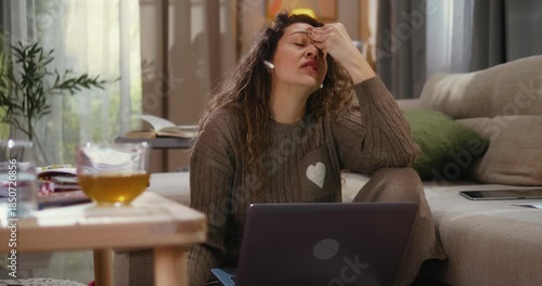 Mother argues during business conference call on a laptop while her daughter and dog interrupt in the background seeking attention. Work from home stress, parenting challenges, and family distraction