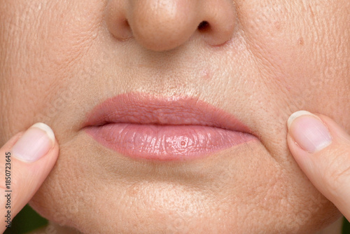 Wallpaper Mural A middle-aged woman examines the expression lines on her face Torontodigital.ca