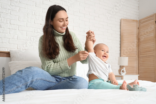 Young mother putting t-shir...