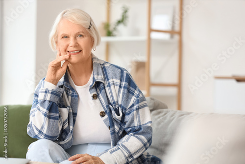 Senior woman sitting on sof...