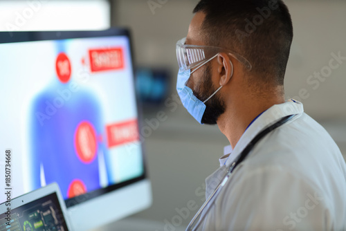 Male doctor analyzing scien...