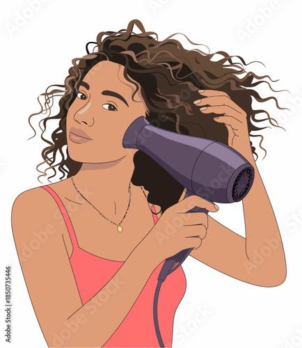 In this image, a young woman is styling her curly hair with a hairdryer, showcasing personal care and confidence in embracing her natural beauty and style.
