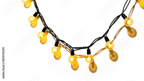Close-up of warm yellow LED string lights on a black wire against a clean white background, creating a festive glow.