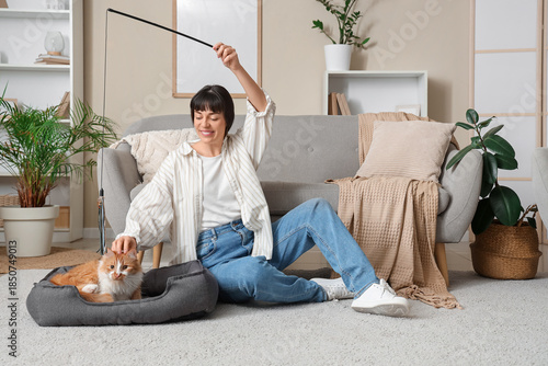 Young woman playing with cu...