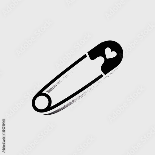 A stylish safety pin featuring a heart design represents vulnerability and connection. It's a modern symbol for care, love, and the journey of self-expression.