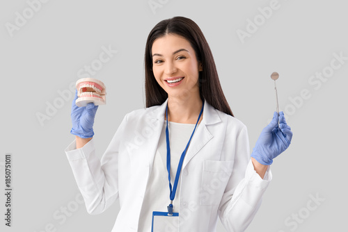 Young female dentist with t...