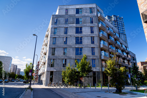 Photography Modern buildings estate in Copenhagen with people, concrete futuristic apartment building in Amagerbro district, life on streets Denmark, Scandinavia