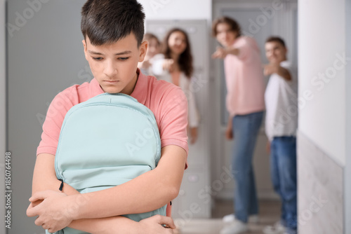 Bullied teenage boy with ba...