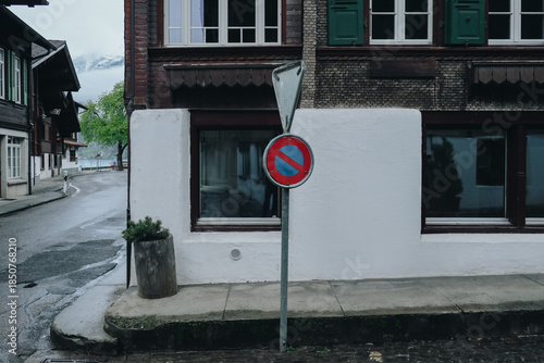 Rainy Day in a European Town with No Parking Sign and Traditional Architecture.