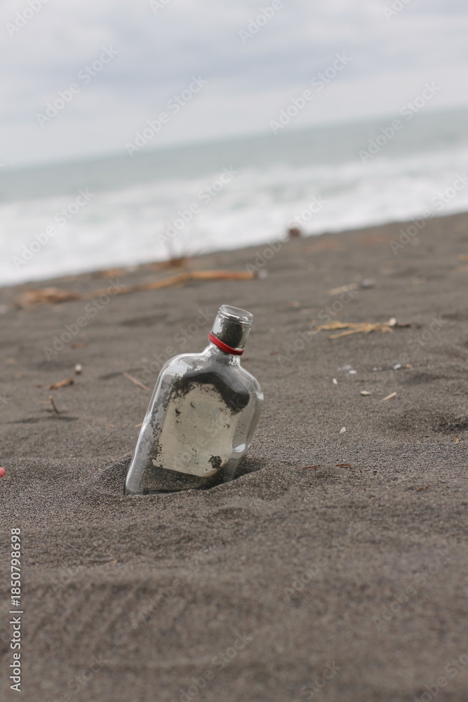 Obraz premium Person Walking Alone on Sandy Beach.