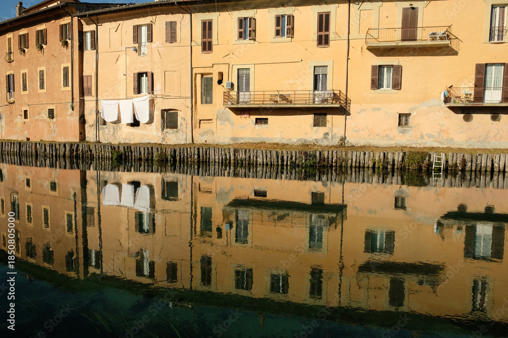 Behang Rieti (Italy) - Houses of historic center of the Sabina's provincial capital with old houses reflections over Velino river