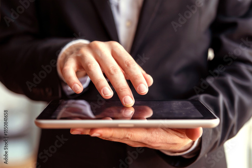 Wallpaper Mural Businessperson Using Digital Tablet with Touchscreen Interface for Modern Mobile Technology Concept Torontodigital.ca