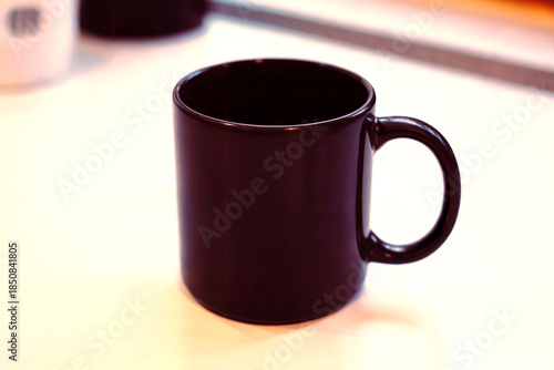 Minimalist Black Coffee Mug on Clean Desk Background with Soft Natural Light