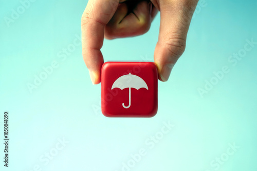 Hand Holding Red Umbrella Icon Symbolizing Insurance Protection and Risk Coverage on Blue Background
