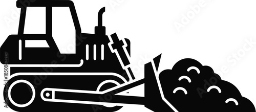 Silhouette of a bulldozer pushing soil