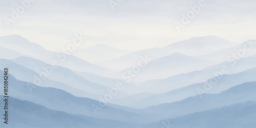 A breathtaking misty mountain landscape at sunset featuring a snow-capped range rising through thick clouds and blue morning haze over a serene forest valley during a golden dawn