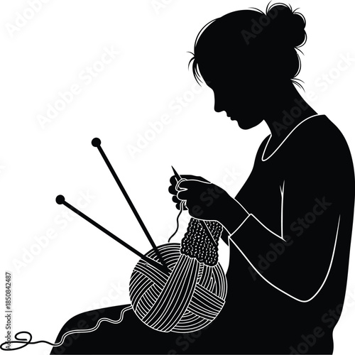 Silhouette of a woman sitting and knitting