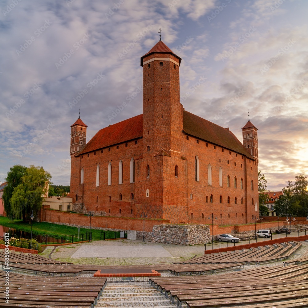 Fototapeta premium view of the Warmian Bishops Palace and the outdoor auditorium in warm evening light