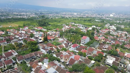 Panoramic aerial view of a sprawling suburban residential area with a mountain in the background.