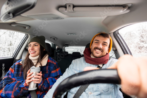 Couple travelling to winter vacation by car