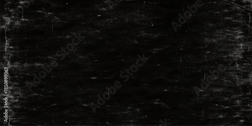 A weathered vintage film strip frame set against a dark textured grunge wall backdrop with an aged grey concrete surface and a dirty black and white pattern