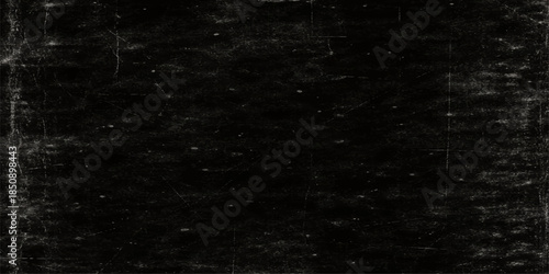 A dark grunge film background with a textured black stone wall pattern and alpha channel features a vintage rough paper surface for a dirty gray industrial backdrop