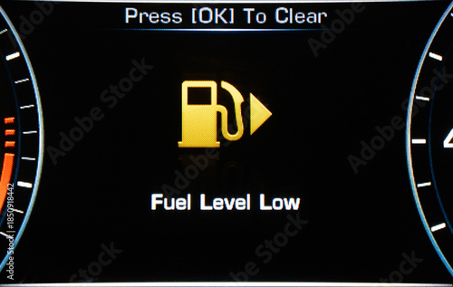 Low Fuel. A car s gas gauge showing low on fuel.  Sensor fuel warning on digital dashboard. Low fuel level.