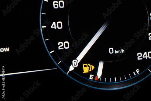 Low Fuel. A car s gas gauge showing low on fuel.  Sensor fuel warning on digital dashboard. Low fuel level.