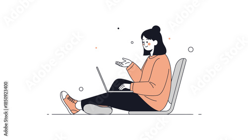 Young woman sitting comfortably on the floor using her laptop with casual attire and relaxed posture