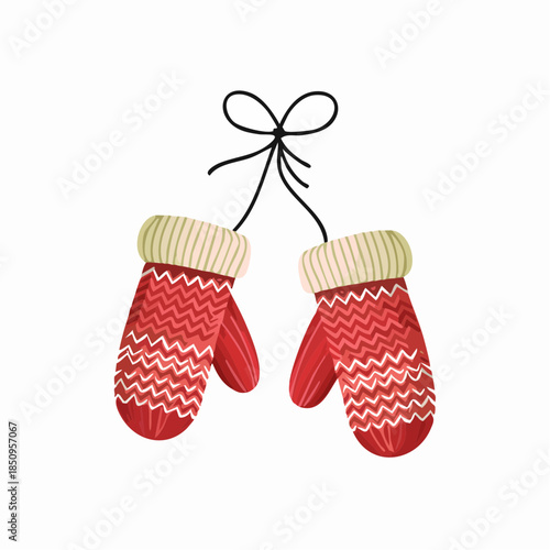 Pair of red mittens with white zigzag patterns hanging on white background