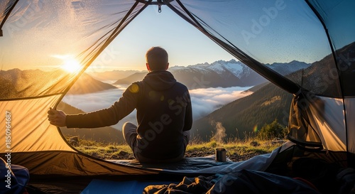Tranquil Campsite Viewpoint at Sunrise with Hiker Watching Misty Mountains and Sunrise