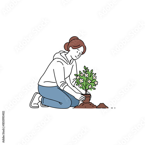 woman gardener kneeling tending sapling in soil.