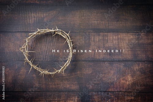 Crown of Thorns on a Rustic Brown Textured Background. Text he is Risen Indeed