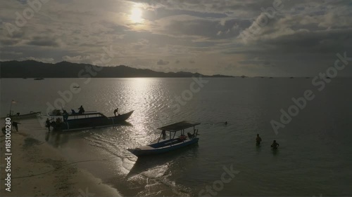 Sunset Over Tropical Beach with Traditional Boats
