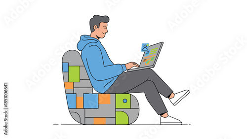 Man sitting on a modern chair working on a laptop.