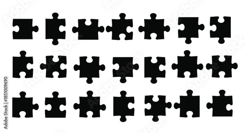 A collection of black puzzle pieces arranged in three rows on a white background with a flat lay composition.