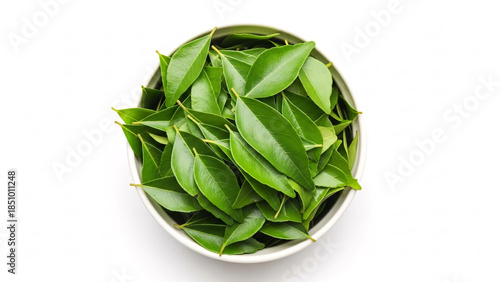 Fresh curry leaves in a small bowl isolated on white