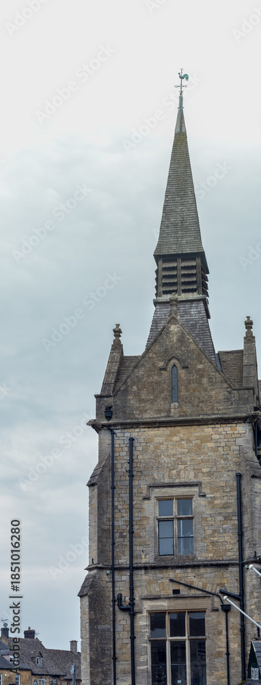 Fototapeta premium Old Stone Church Tower With Weather Vane