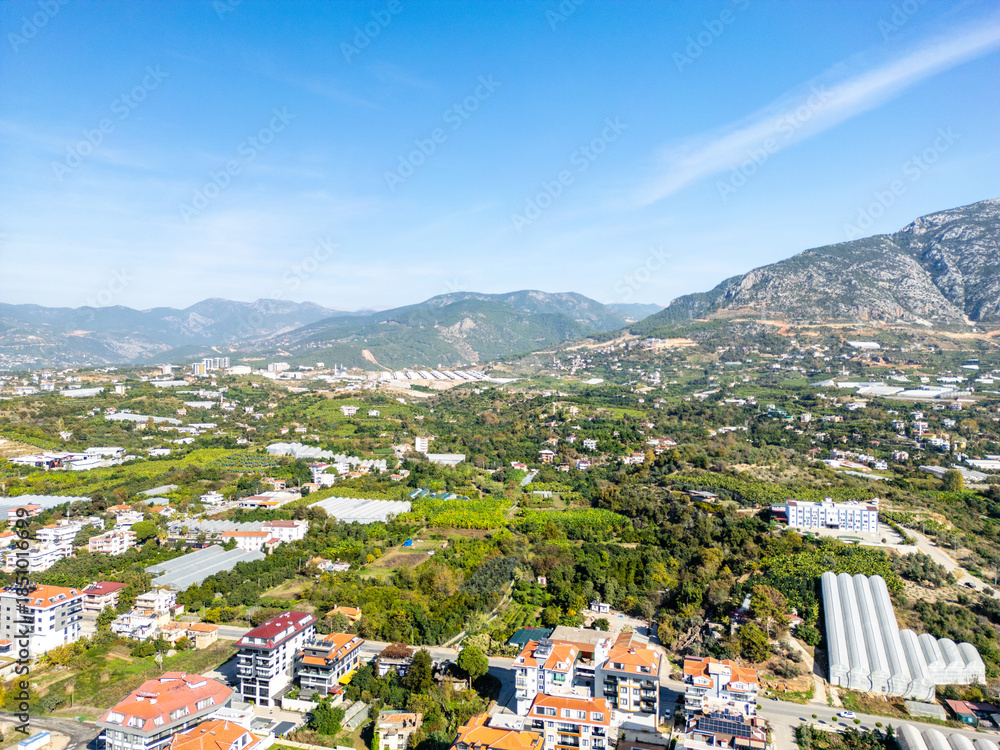 Fototapeta premium High-Angle Aerial View of the Fertile Valley Floor Near Alanya, Showing a Mix of Residential Development and Agricultural Greenhouses