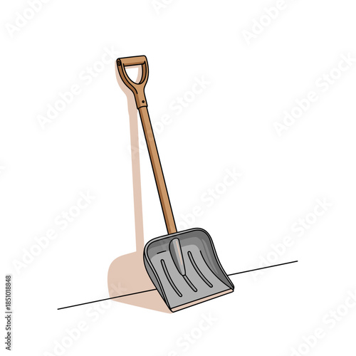 Snow shovel with wooden handle leaning against the wall  