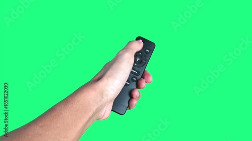 Wallpaper Mural Footage of a human hand holding a remote control and pressing the power on button on a green screen background. Ideal for television concepts, electronic devices, smart home visuals, usage tutorials,  Torontodigital.ca