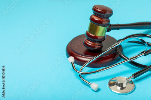 A stethoscope and hammer on a desk. Medical malpractice, personal injury lawyer, and healthcare legal aspects concept.Lawyer.Legal definition of medical negligence. Law concept.Healthcare and Medicine